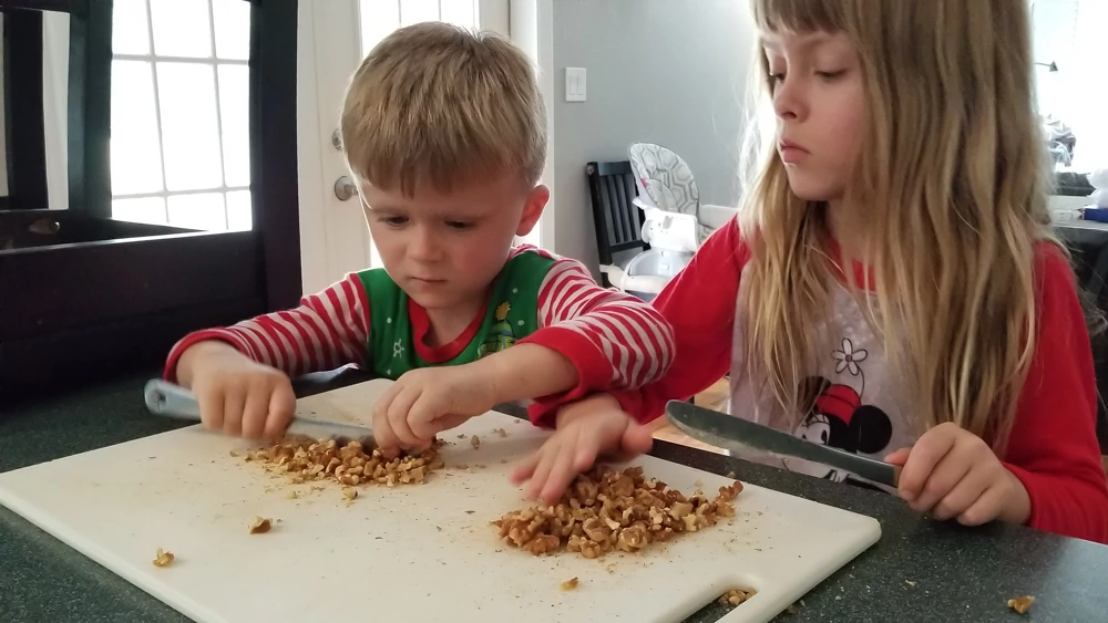 cookie baking Christmas activity for kids. They can help measure, mix and chop nuts.