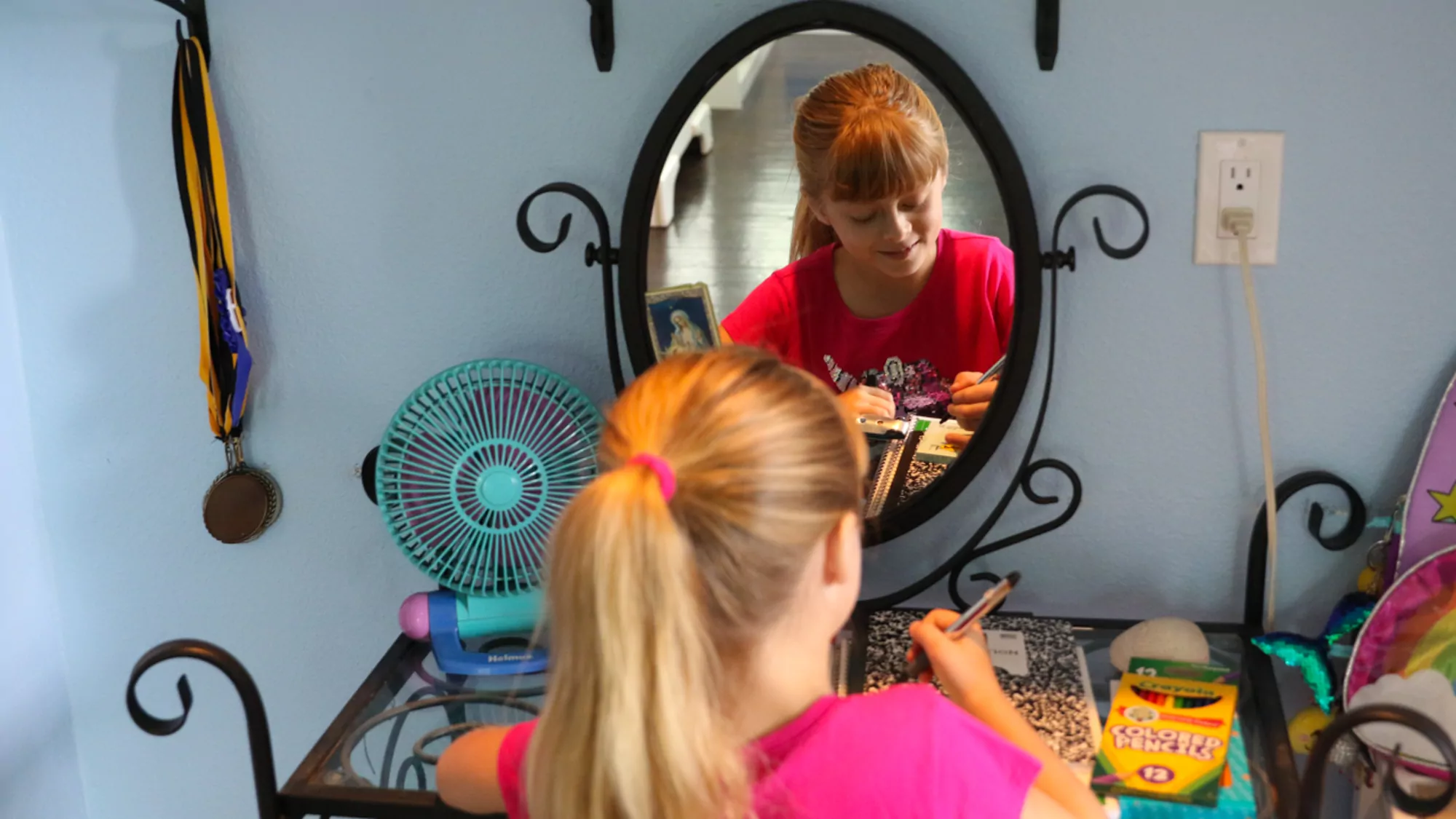 Girl labeling school supplies and getting ready with her back to school morning routine tips